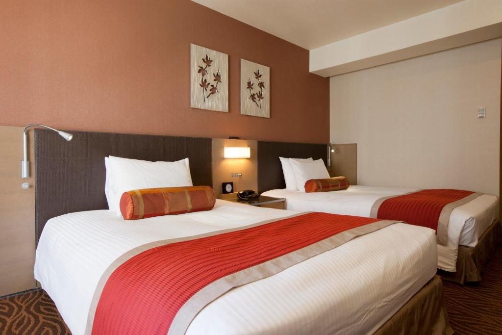 Postel nebo postele na pokoji v ubytování Hotel Sardonyx Tokyo