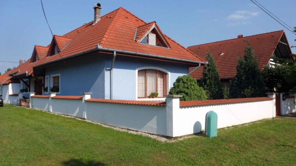 a blue and white house with a red roof at Apartment in Balatonbereny - Balaton 18043 in Balatonberény