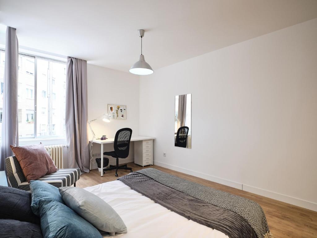 A bed or beds in a room at My City Home - Student Rooms in Moncloa
