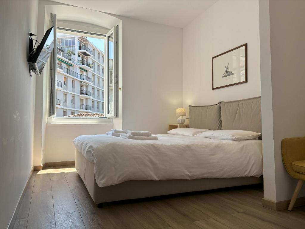 a bedroom with a large bed and a window at Il Sigillo in Trieste