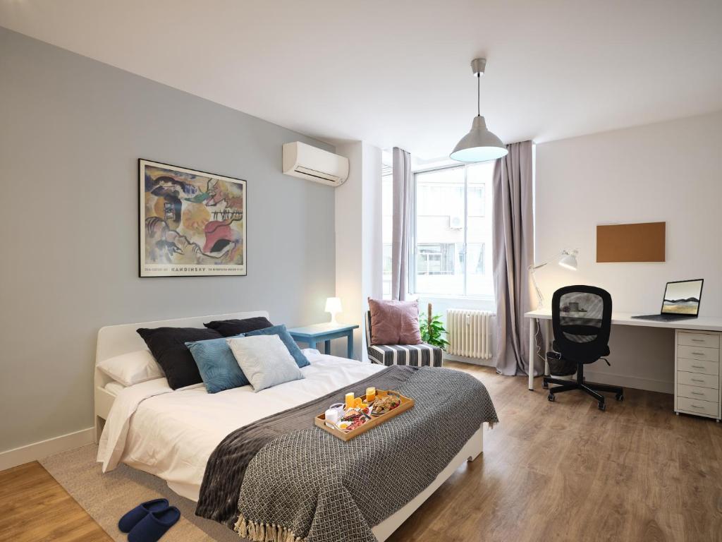A bed or beds in a room at My City Home - Student Rooms in Moncloa