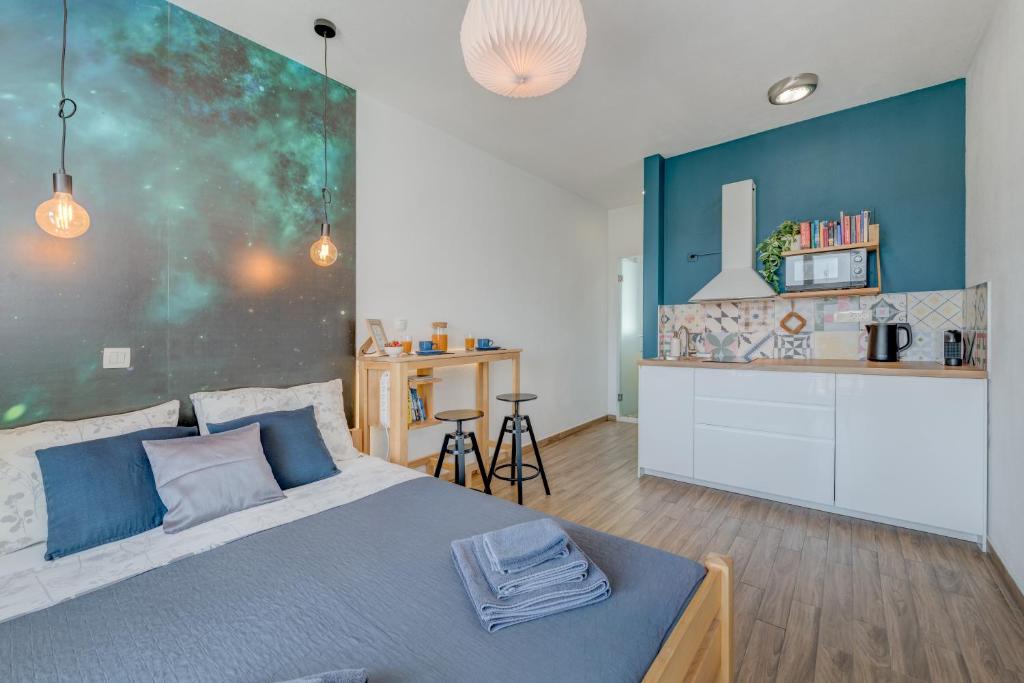 a bedroom with a bed and a kitchen at Trogir Downtown Apartments in Trogir