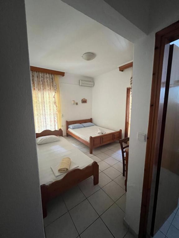 Posteľ alebo postele v izbe v ubytovaní Boufidis Rooms