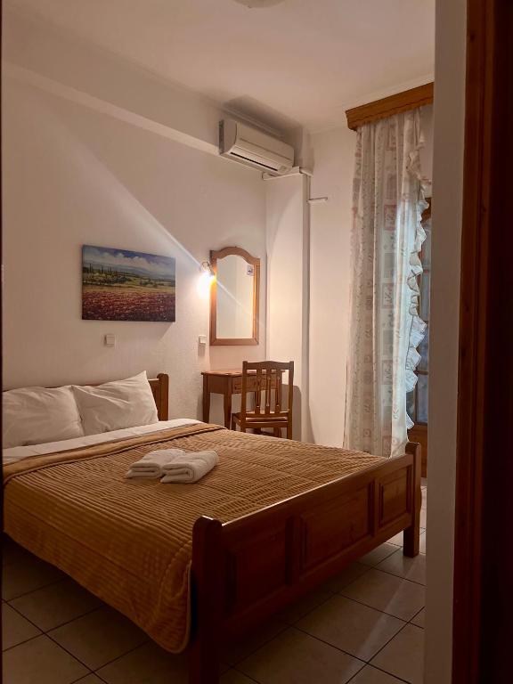 Posteľ alebo postele v izbe v ubytovaní Boufidis Rooms