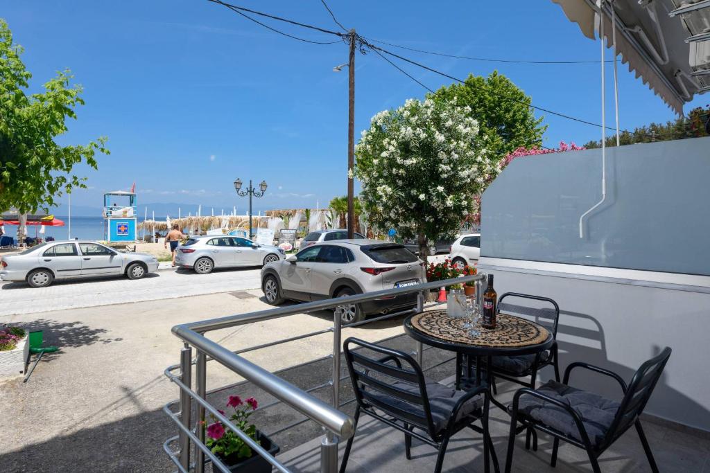 a patio with a table and chairs on a balcony at Chara Sea View Luxury House in Limenas