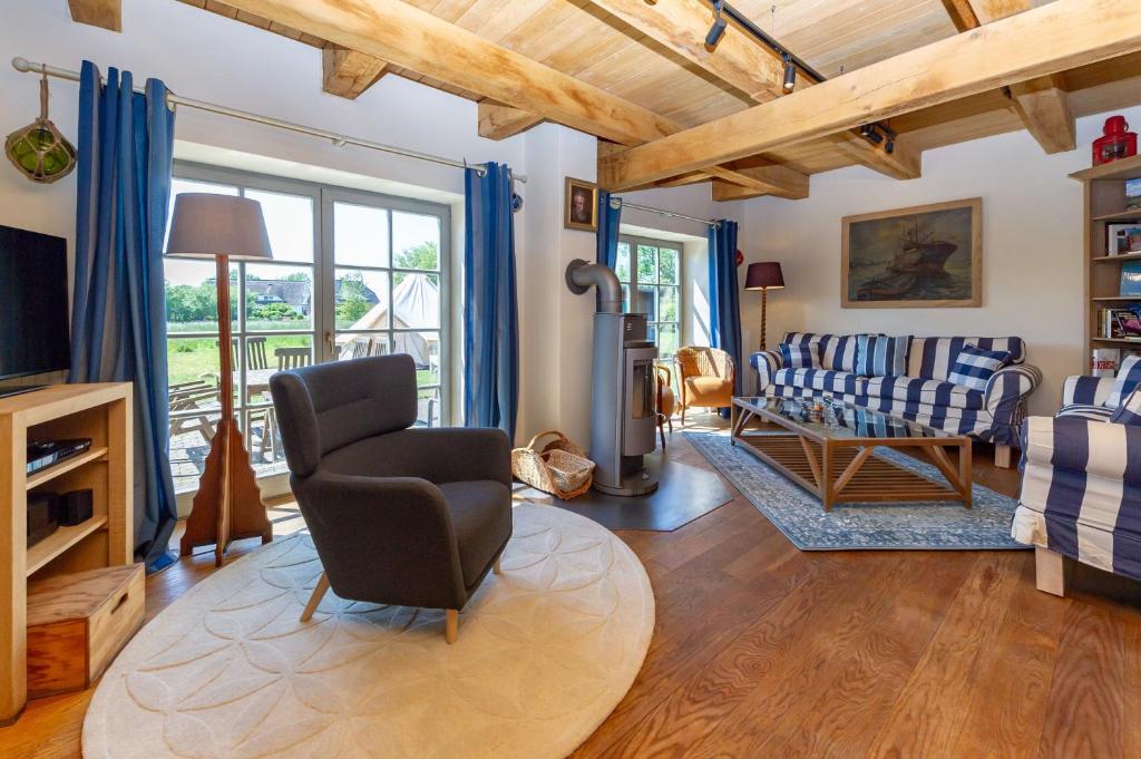 a living room with a couch and a chair at Fachwerkhäuser Gager - Haus 2 in Gager