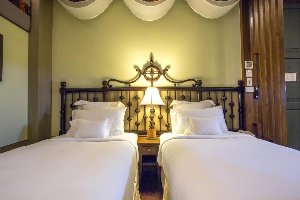 Postel nebo postele na pokoji v ubytování Chankam Boutique Hotel