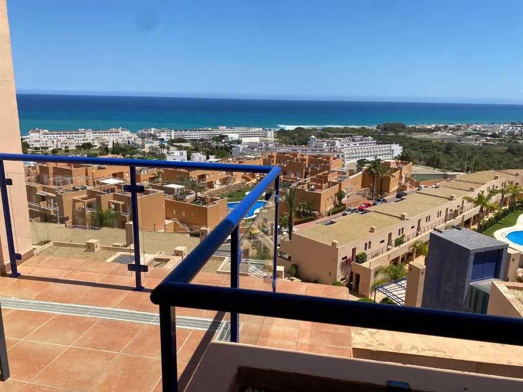 a balcony with a view of a city and the ocean at SUNRISE ATALAYA Amanecer suite in Mojácar