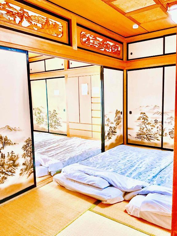 Postel nebo postele na pokoji v ubytování T&T Fujiyama Guest House