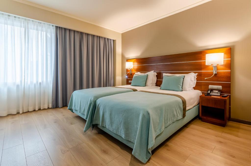 Postel nebo postele na pokoji v ubytování TURIM Europa Hotel