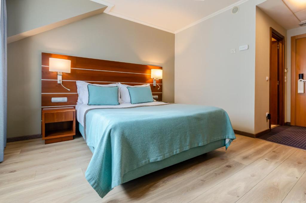 Postel nebo postele na pokoji v ubytování TURIM Europa Hotel