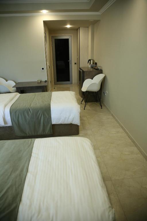 Postel nebo postele na pokoji v ubytování Vell Grey Hotel