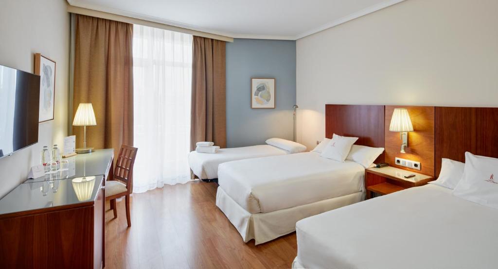 Postel nebo postele na pokoji v ubytování Sercotel Los Llanos