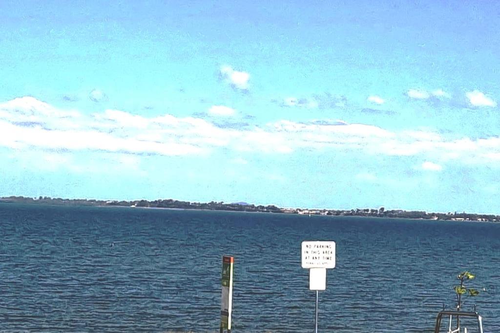 a sign in the middle of a large body of water at Vandy Beach Cottage in Clontarf