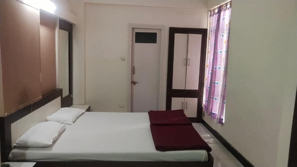 Postel nebo postele na pokoji v ubytování Hotel Vaishali