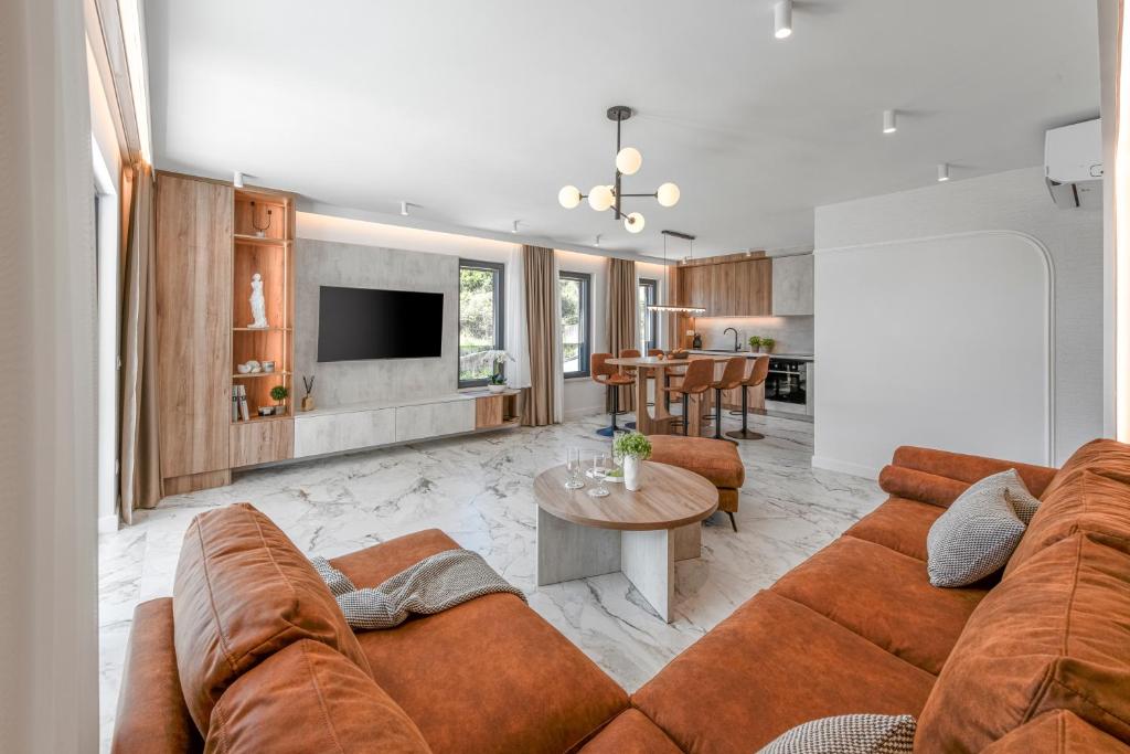 a living room with a couch and a table at Azzurea Residence in Zaton