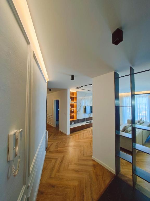 a room with a hallway with a bed and a mirror at The Loft Luxury Apartment in Shkodër