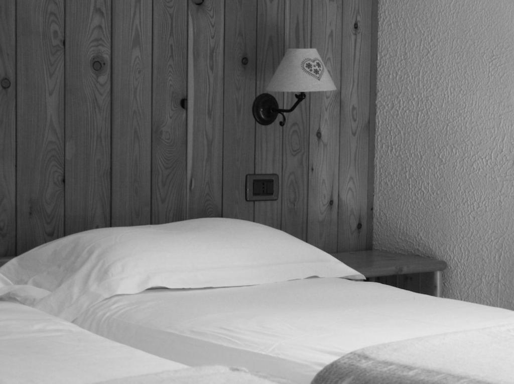 Postel nebo postele na pokoji v ubytování Orso Bianco Hotel & Chalet