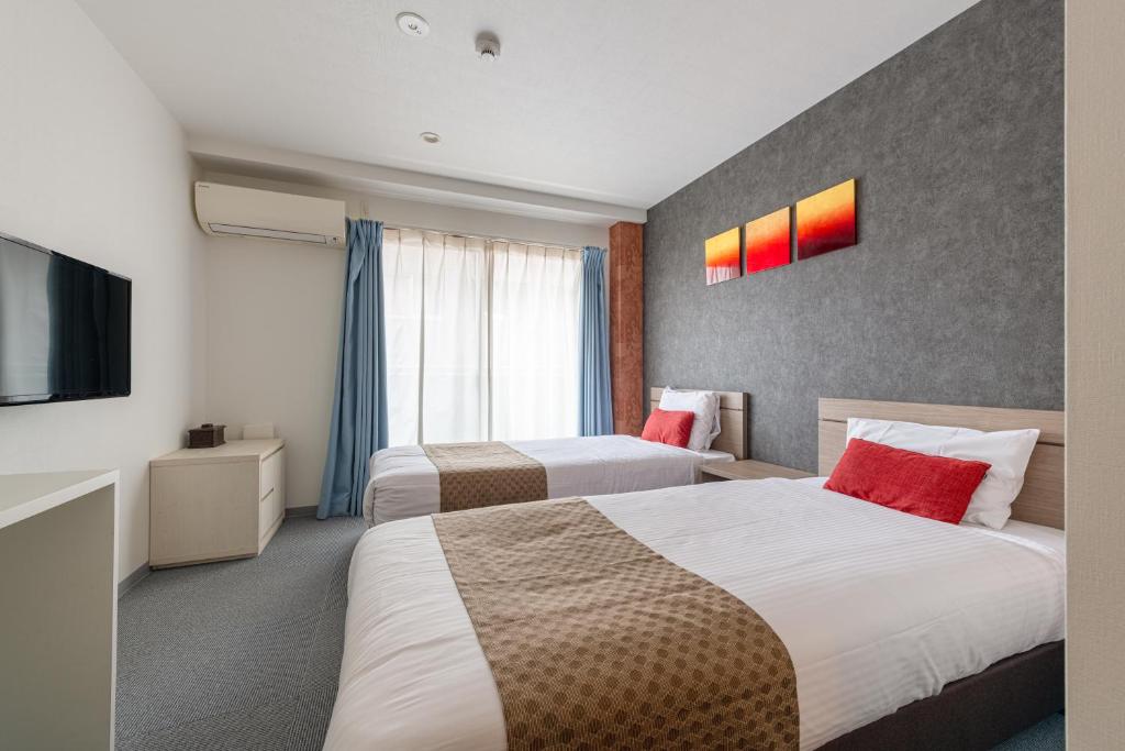 Postel nebo postele na pokoji v ubytování Komachi Hotel Nipponbashi