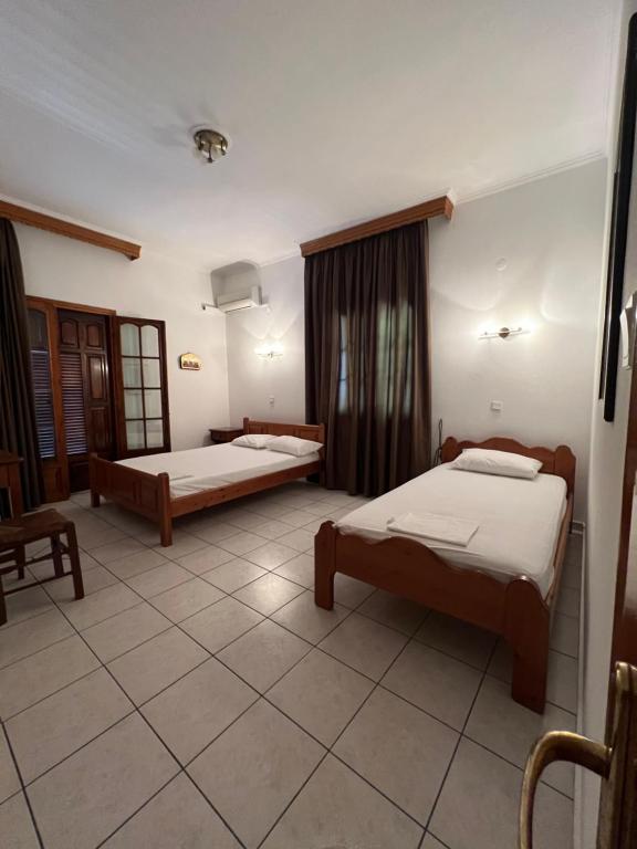 Posteľ alebo postele v izbe v ubytovaní Boufidis Rooms