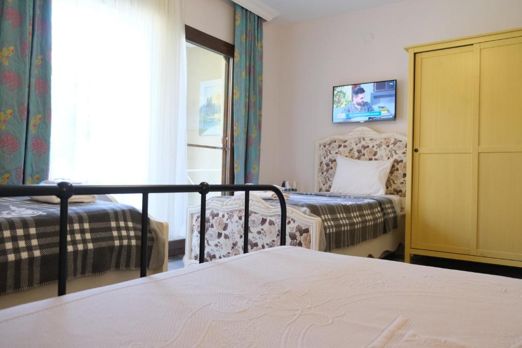 Postel nebo postele na pokoji v ubytování Nilüfer Butik Otel