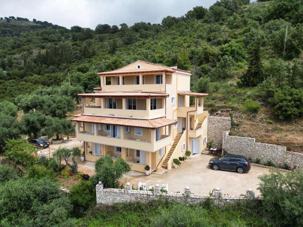a house with a car parked in front of it at Nefeli's Apartment in Himare