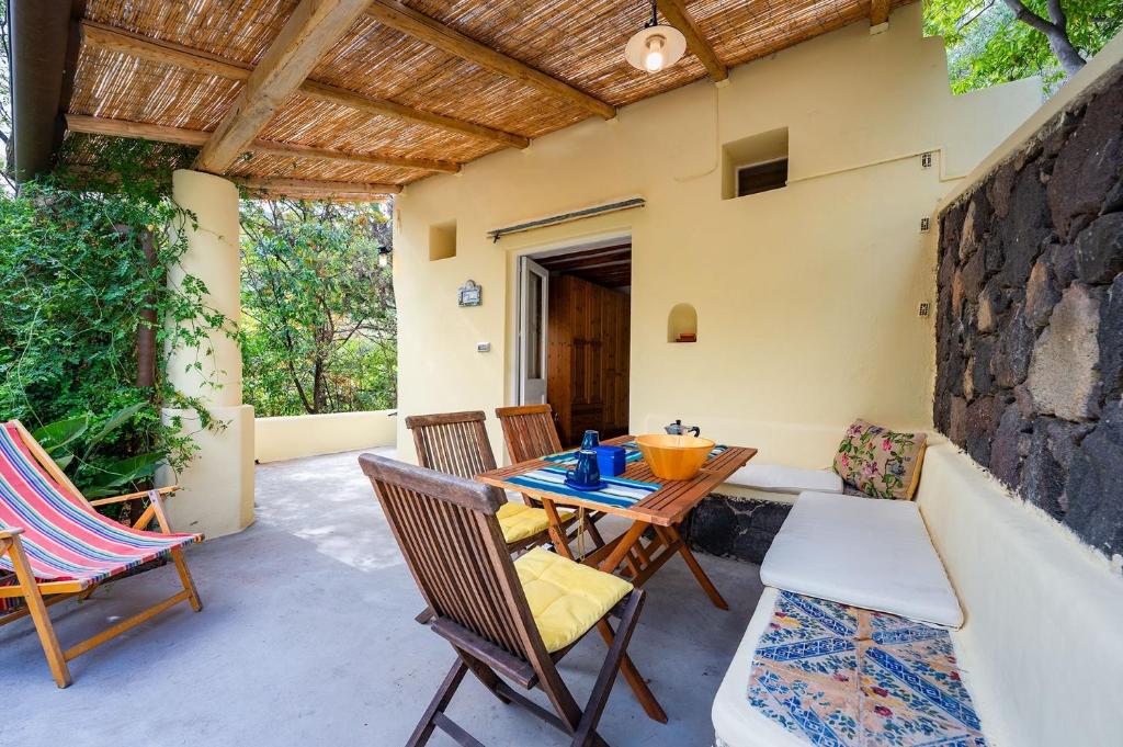 a patio with a table and chairs and a building at Casa Scirocco Lipari in Lipari