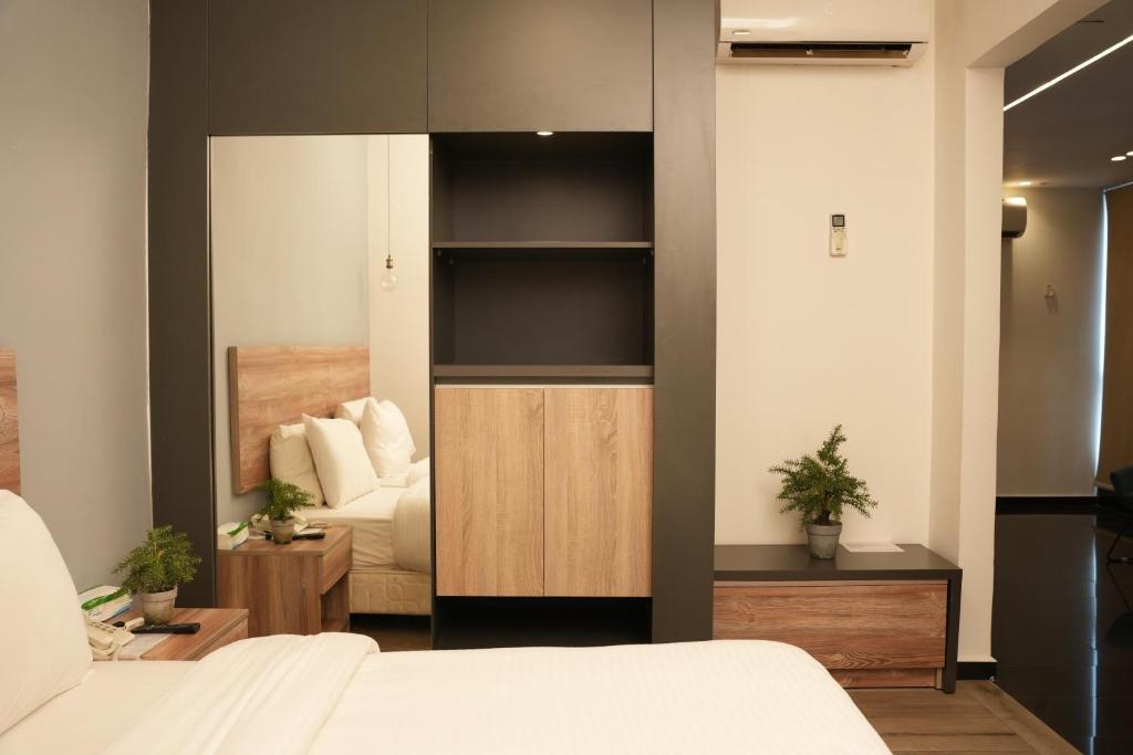 a room with a bedroom with a bed and a mirror at B RESIDENCE in Beirut