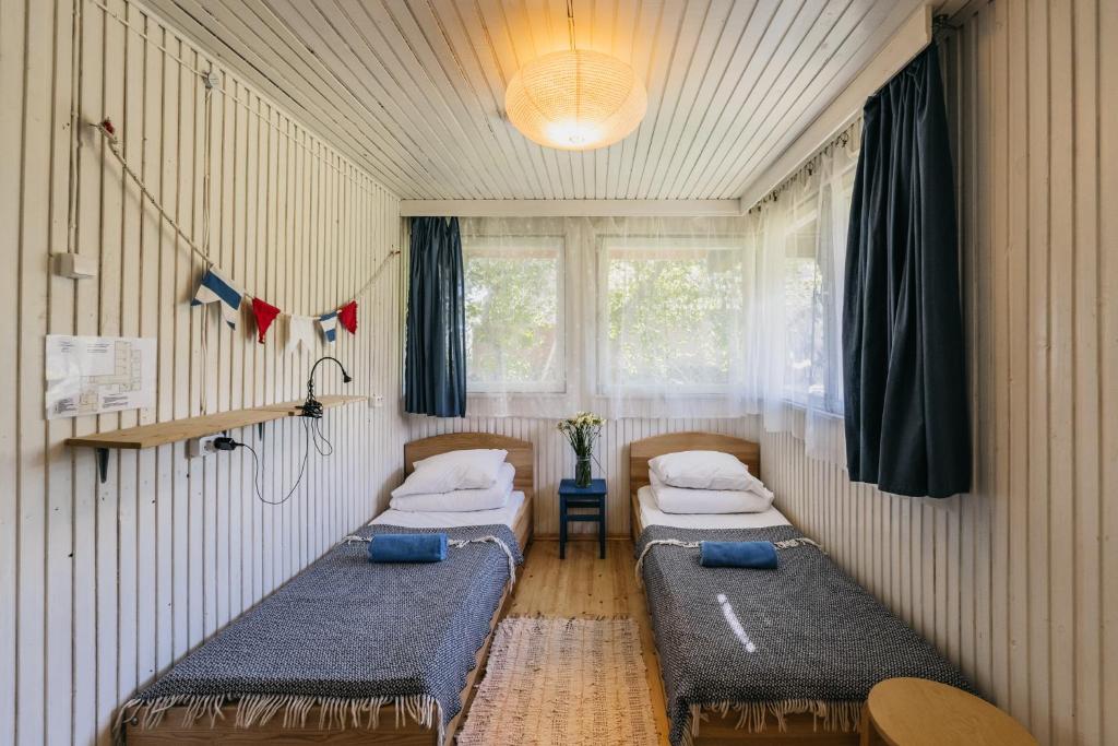 a room with two beds in a room at Guboja in Nida