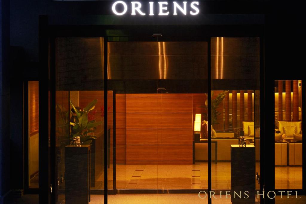 an open door of a hotel with a sign on it at Oriens Hotel & Residences Myeongdong in Seoul