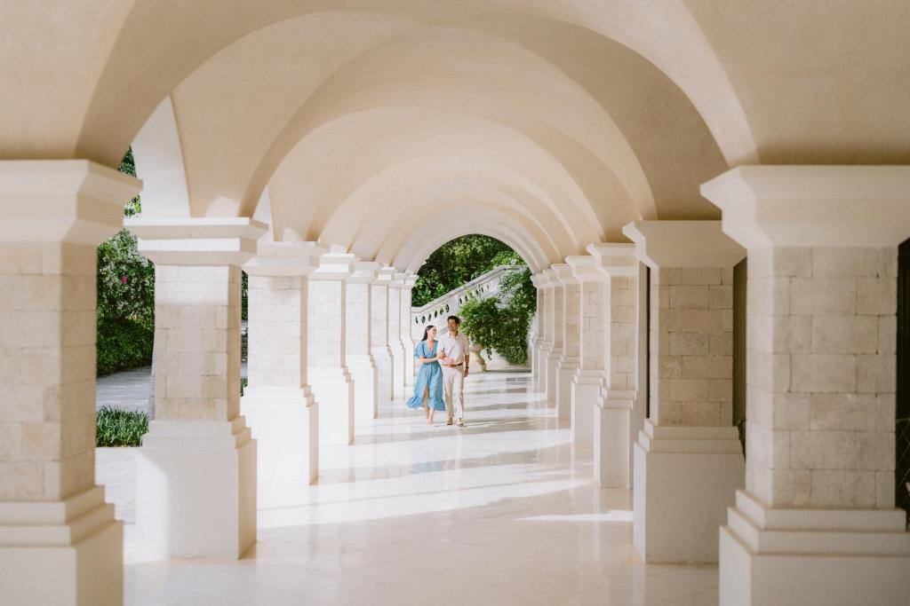 a couple standing in an archway of a building at Jumeirah Bali in Uluwatu