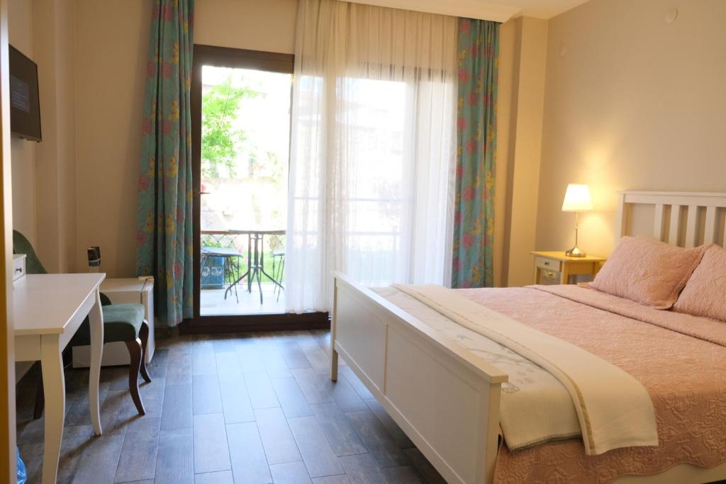 Postel nebo postele na pokoji v ubytování Nilüfer Butik Otel