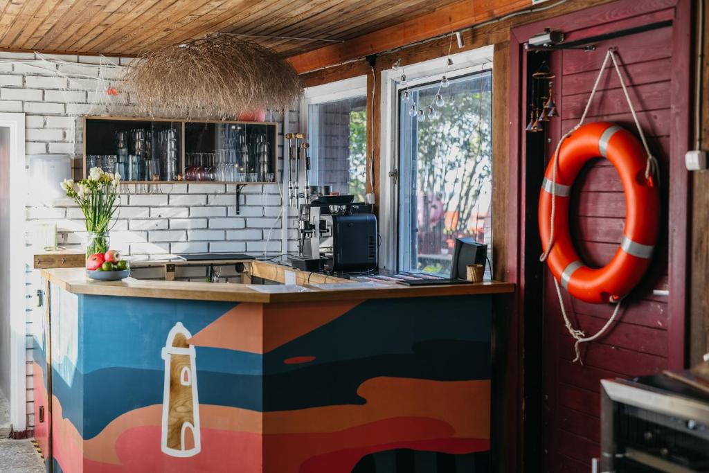 a kitchen with a colorful island with an orange life preserver at Guboja in Nida