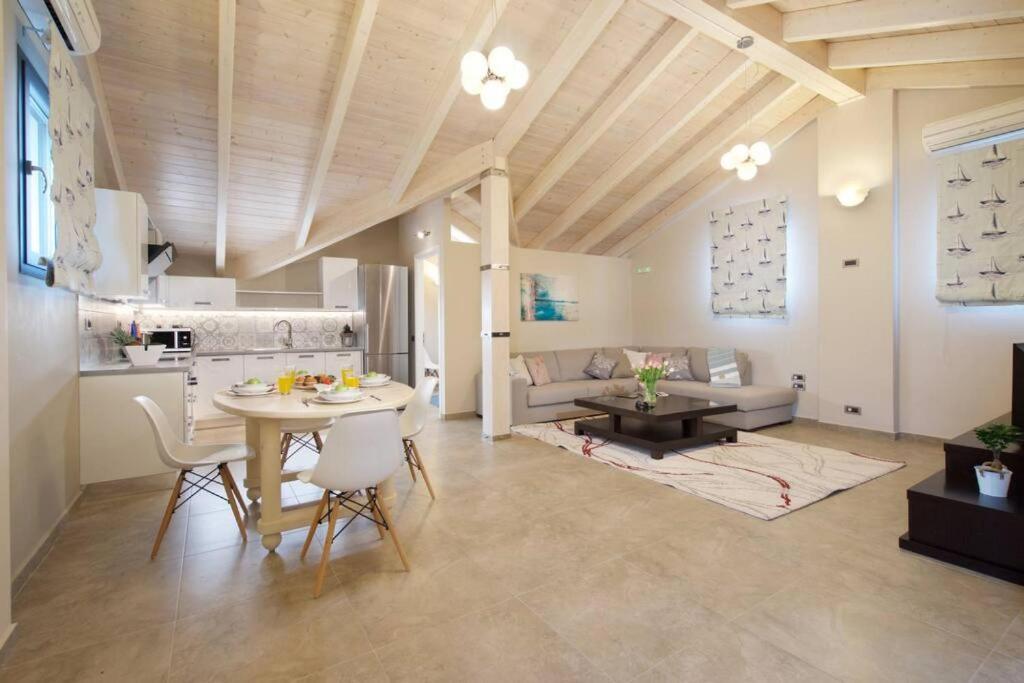 a living room with a table and a couch at Loft Centre Square Penthouse in Argostoli