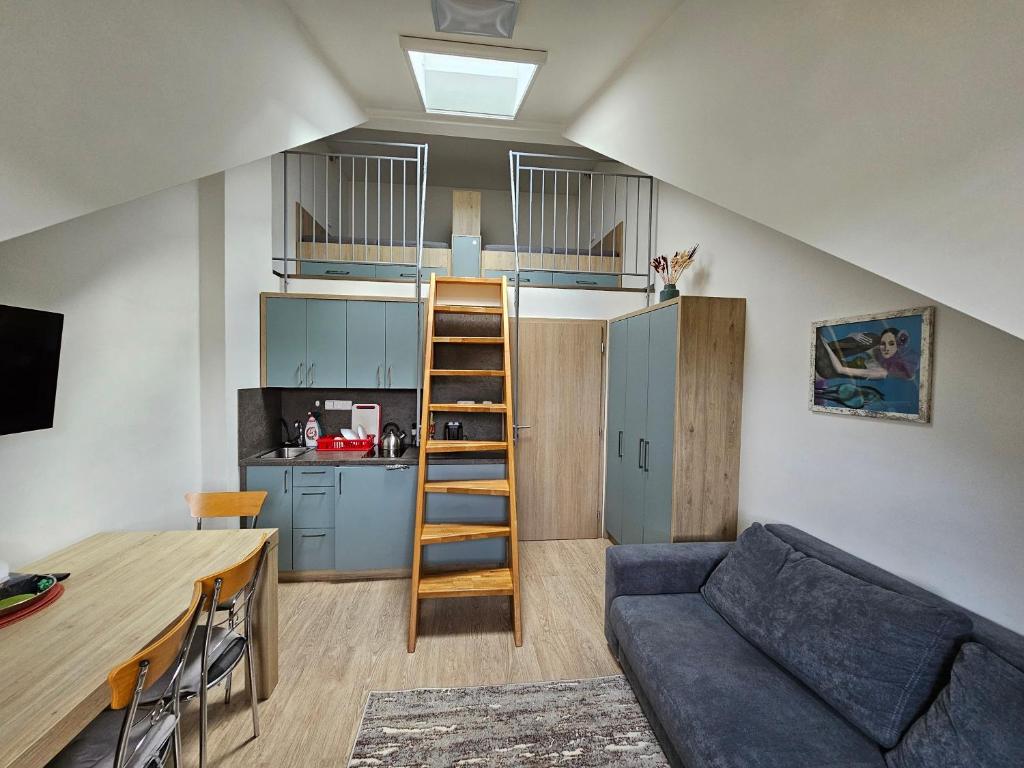 a living room with a couch and a kitchen at Apartmán Lipa, Loučná nad Desnou in Loučná nad Desnou
