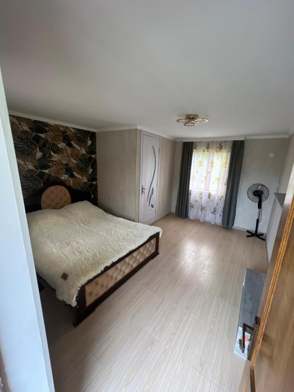 a bedroom with a bed in the middle of a room at Hotel-Restaurant Khvanchkara in Khvanchkara