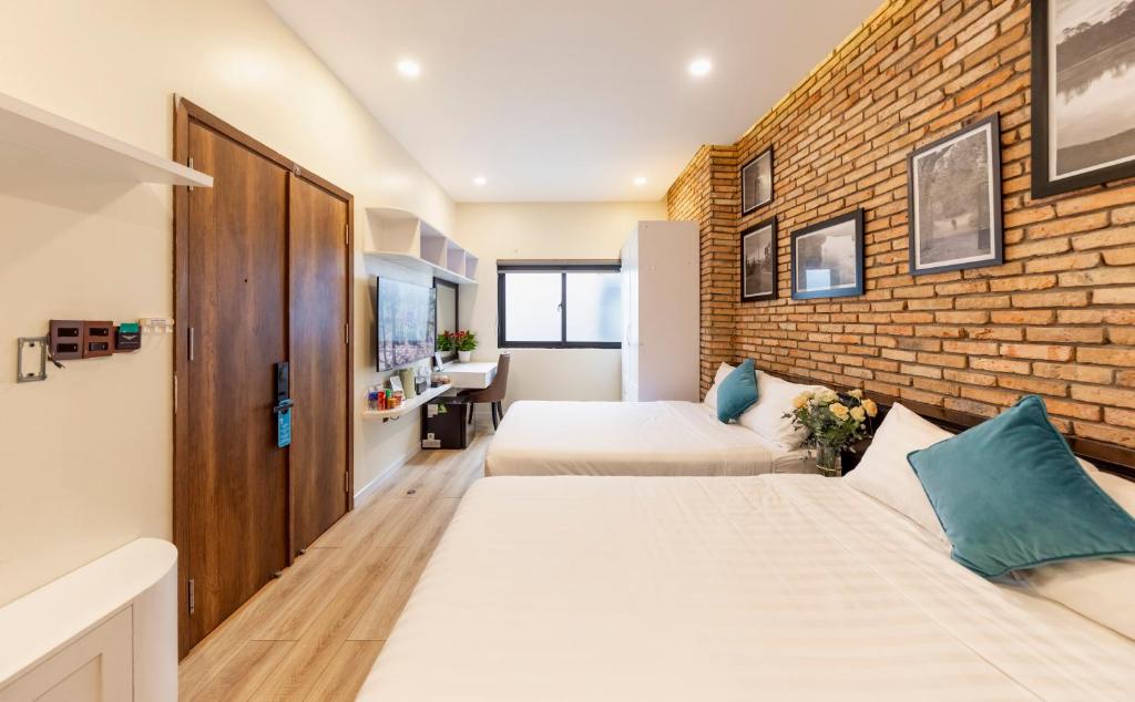 Postel nebo postele na pokoji v ubytování The Brick Home dalat