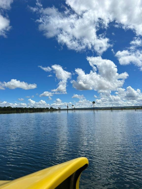 a yellow boat on a body of water at Pontal da lagoa in Planaltina