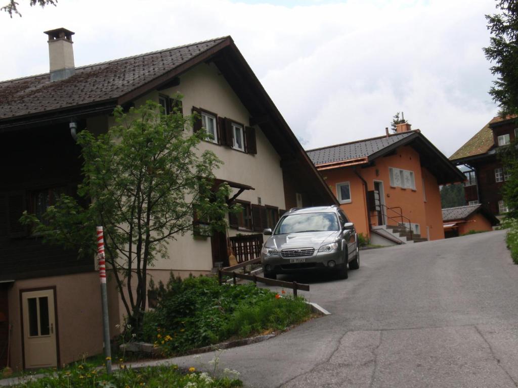 a car parked in front of a house at Chalet Tannenrain & Casa Alba in Arosa