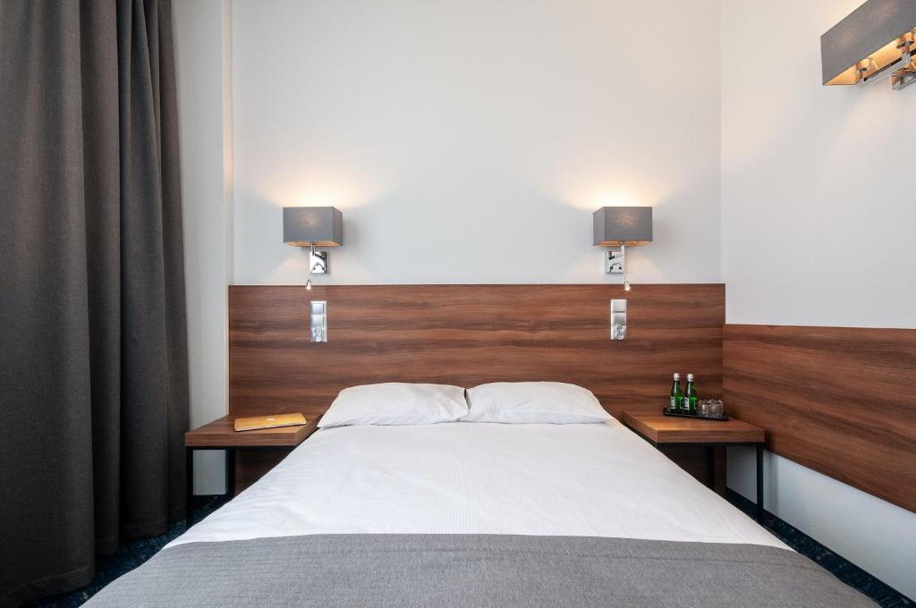 Posteľ alebo postele v izbe v ubytovaní Hotel Oliwski
