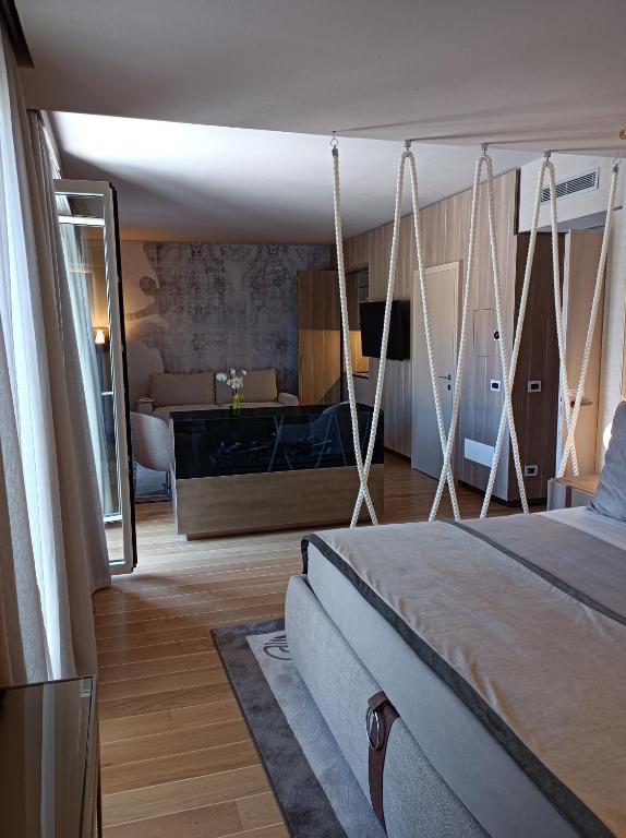 a bedroom with a swing bed and a tub at Miramare Suites in Sestri Levante
