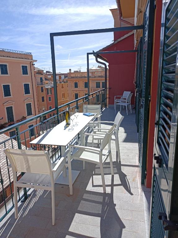 a table and chairs on the balcony of a building at Miramare Suites in Sestri Levante