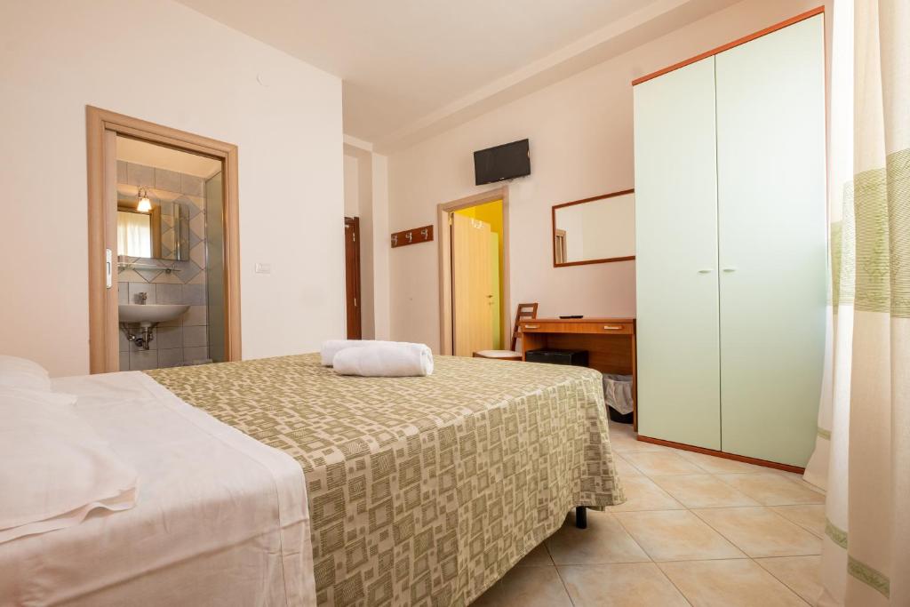 Postel nebo postele na pokoji v ubytování Hotel Il Gabbiano