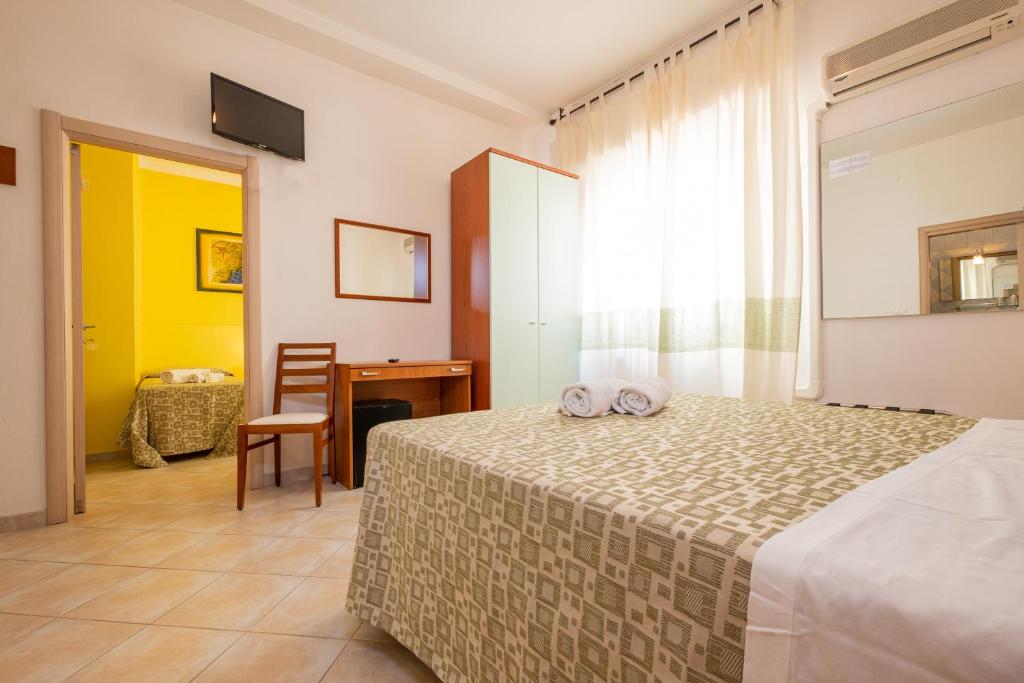 Postel nebo postele na pokoji v ubytování Hotel Il Gabbiano