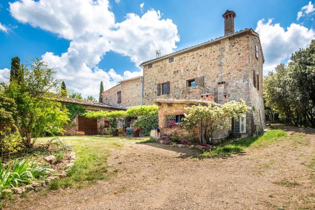 an external view of a stone building with trees at Casa Verde a Murlo in Murlo