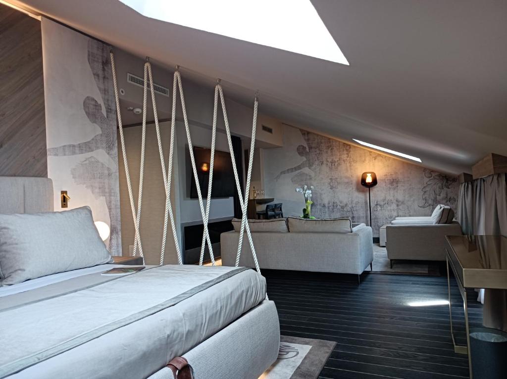 a bedroom with a bed and a living room at Miramare Suites in Sestri Levante