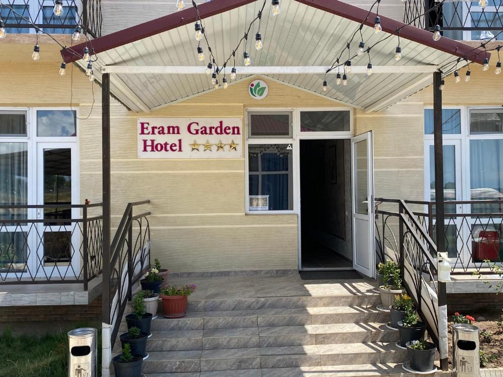 a building with a sign that reads farm garden hotel at Eram Garden Hotel in Bosteri