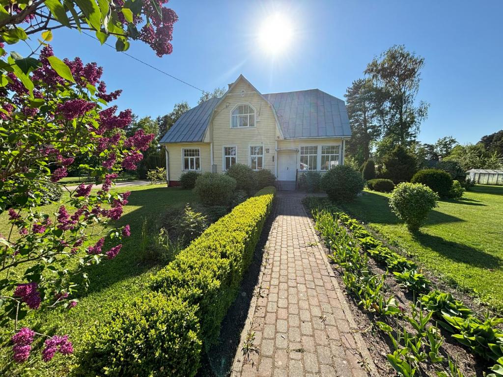a house with a brick walkway in front at Peaceful summer house - Sunshine in Jūrmala