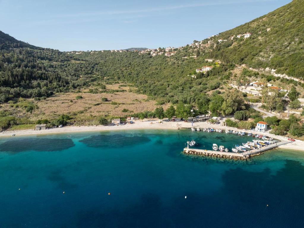 an aerial view of a beach with a dock in the water at ONIRO Villas in Stavros