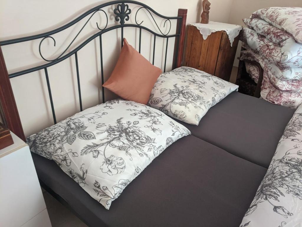 a bed with two pillows on top of it at KOKOPEPINO in Litomyšl